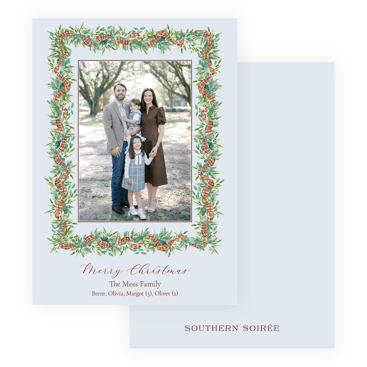 Personalized Christmas photo card with vertical family portrait surrounded by watercolor evergreen greenery, pinecones and plaid ribbon.