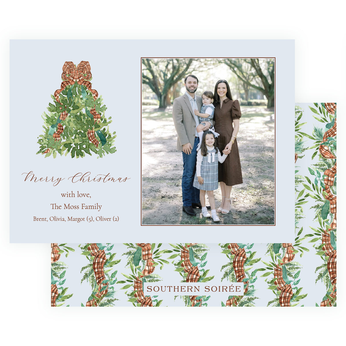 Personalized Christmas photo card with watercolor evergreen tree wrapped in plaid ribbon beside a family portrait on a soft blue background.