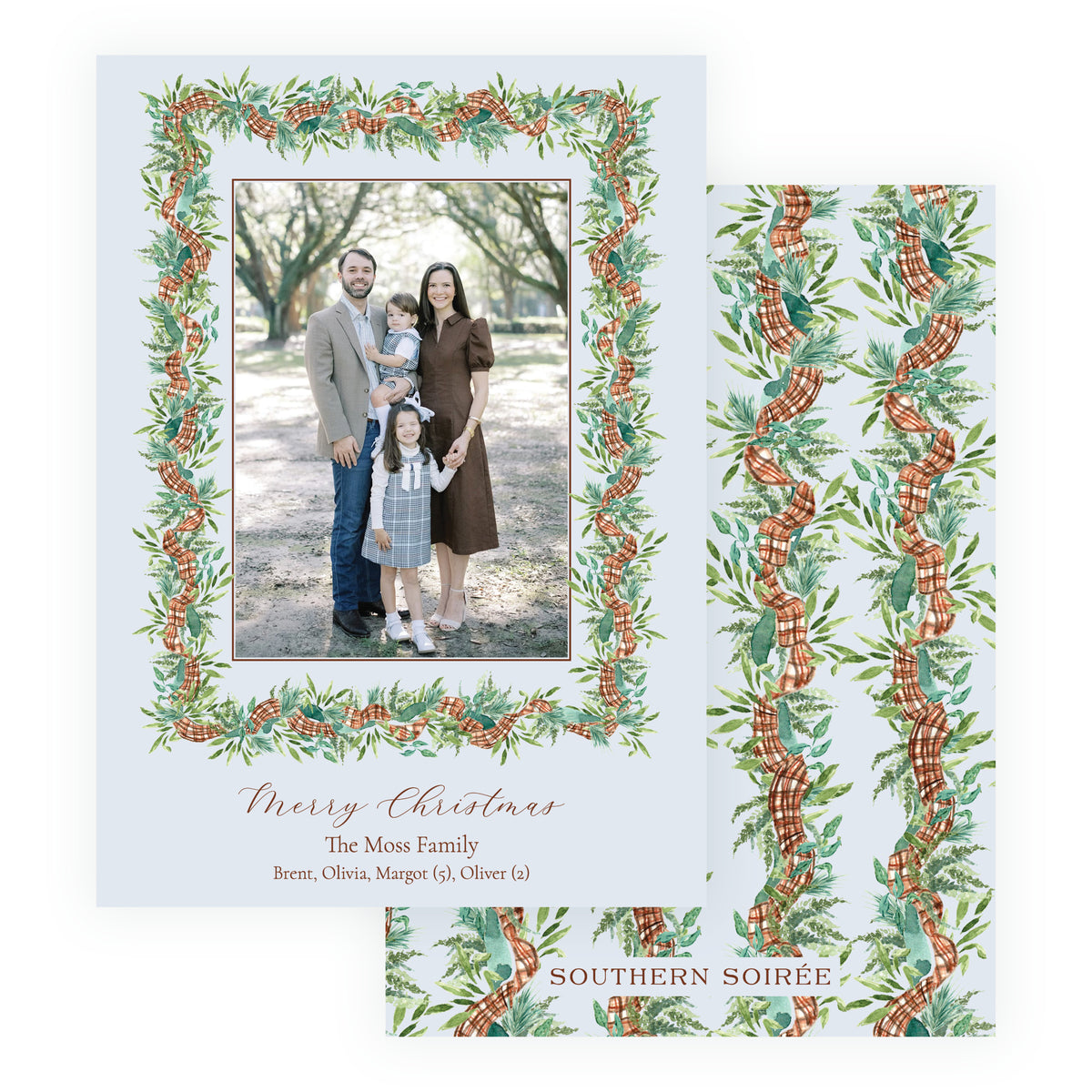 Personalized Christmas photo card with vertical family portrait surrounded by watercolor evergreen greenery, pinecones and plaid ribbon.