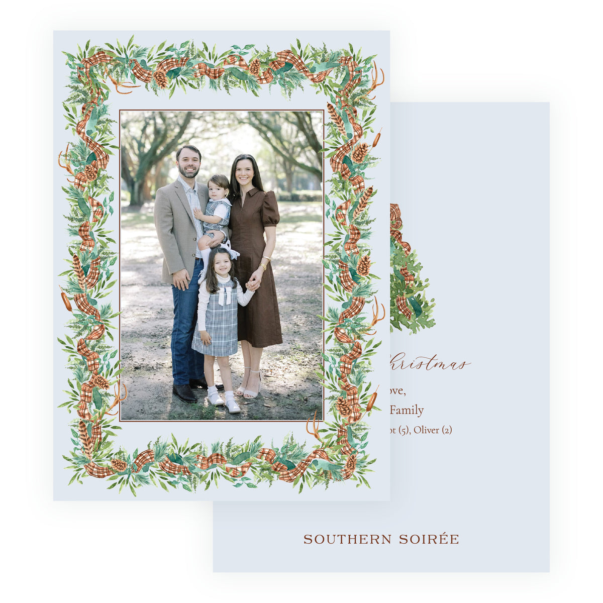 Full photo personalized Christmas card featuring a large family portrait framed by watercolor woodland greenery, pinecones and plaid ribbon.