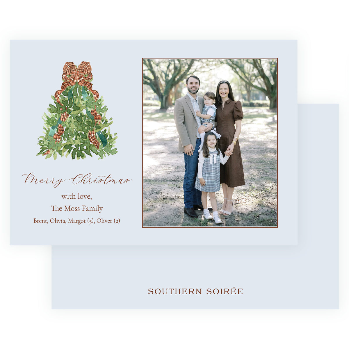 Personalized Christmas photo card with watercolor evergreen tree wrapped in plaid ribbon beside a family portrait on a soft blue background.