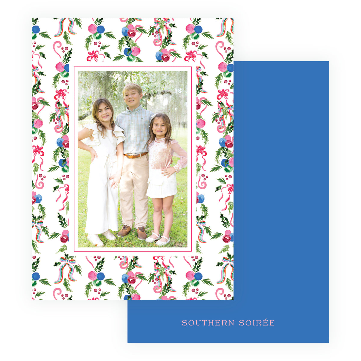 A Southern-themed holiday photo card with a white border decorated with pink ribbons, green holly leaves, and blue pink and red ornaments, featuring a central photo. 
