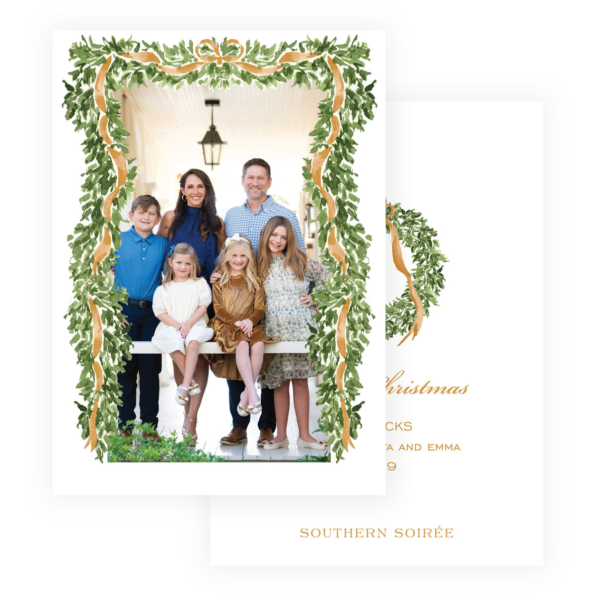 Personalized family Christmas photo card surrounded by greenery and gold ribbon
