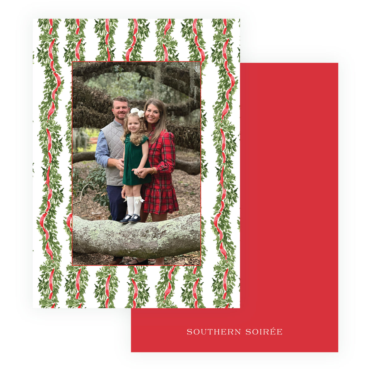 A holiday-themed photo card set featuring a white card with a green holly and red ribbon border and a central family portrait
