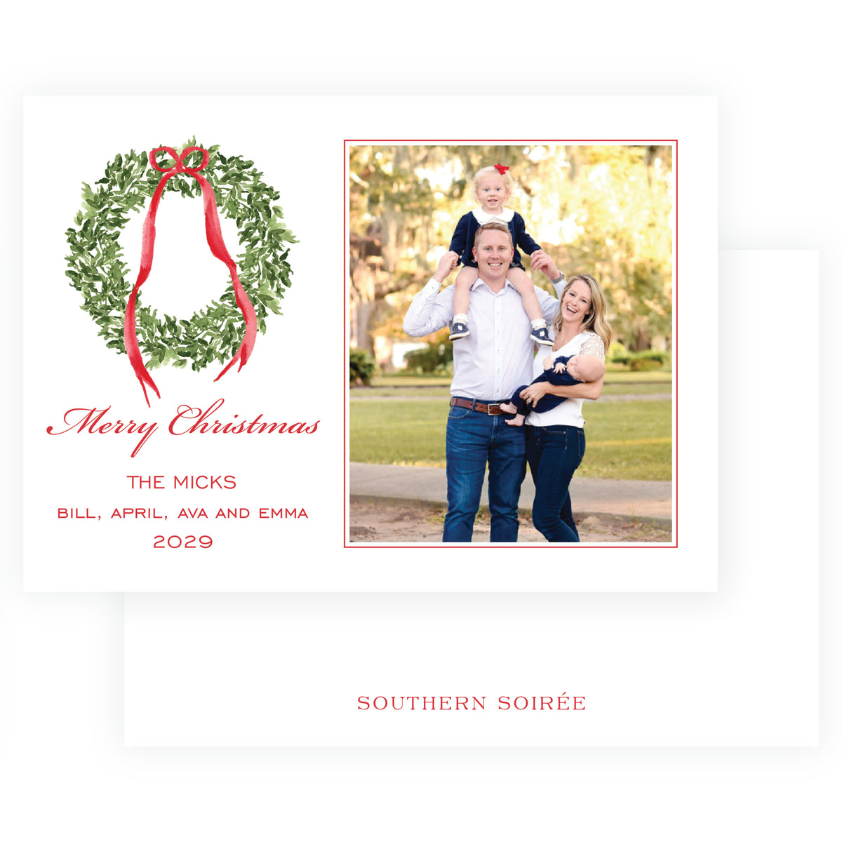 Landscape family Christmas card with evergreen wreath and red ribbon