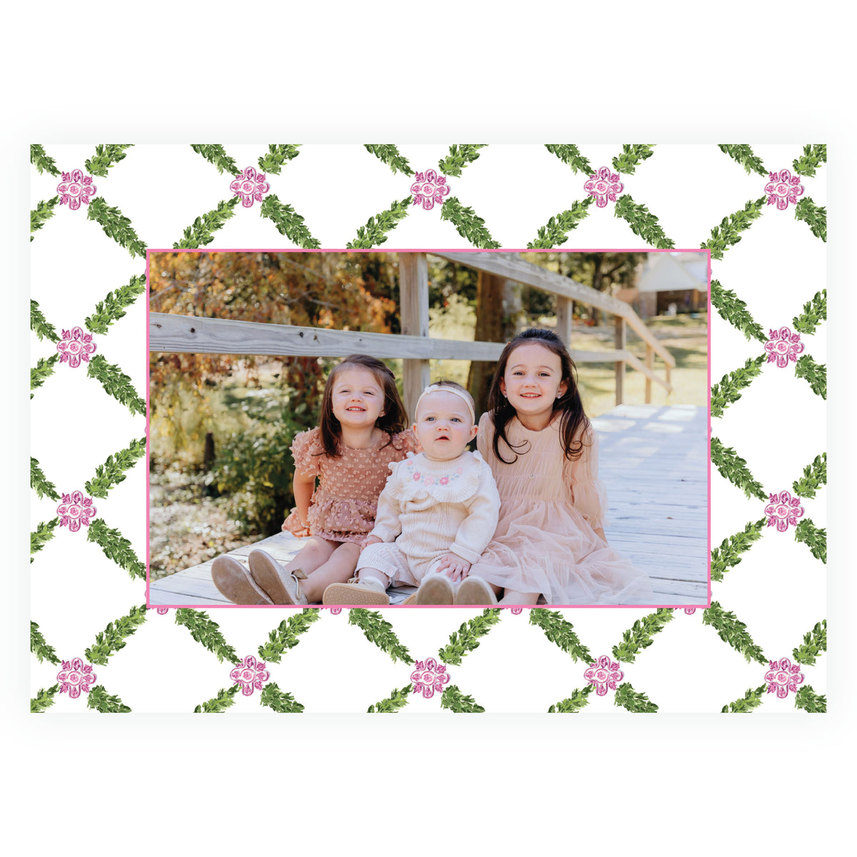 Landscape family Christmas card with evergreen lattice and pink accents